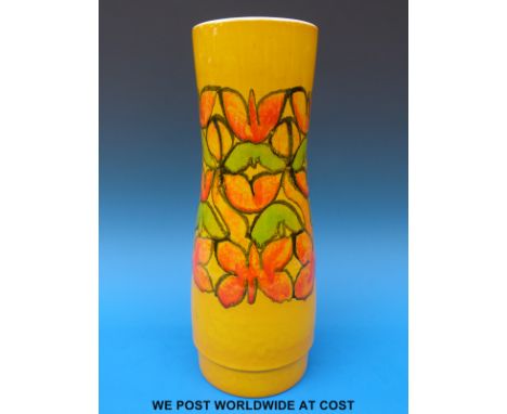 A large retro Poole pottery vase with decoration of flowers on a yellow ground, 40cm tall