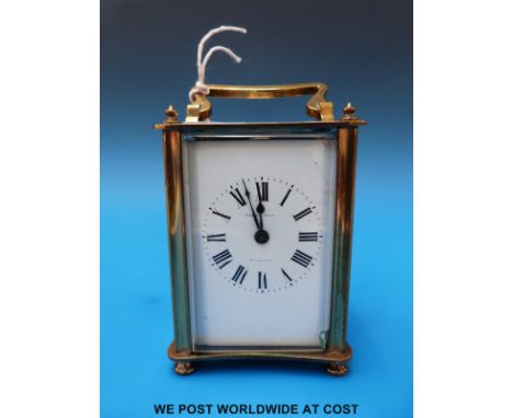 A brass cased carriage clock with enamel face, maker Nicolas Schai and marked Alexandrie (with key)