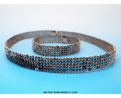 A Georgian/ early Victorian cut steel and white metal choker formed of five rows of single faceted cut steel stones with hand