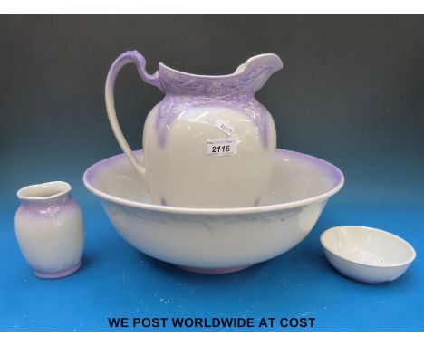 A toilet set decorated with birds and a jug and basin set with mauve decoration