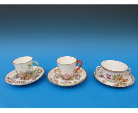 Two Naples/Capodimonte relief decorated cups and saucers and a Dresden example