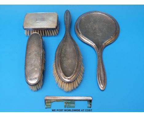 A quantity of hallmarked silver mounted dressing table items comprising hand mirror, comb and three various brushes