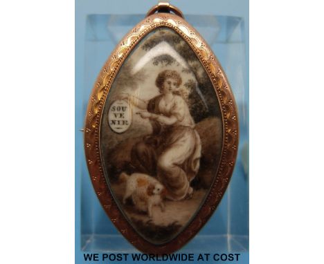 A Georgian marquise shaped yellow metal pendant/brooch set with a painted ivory plaque depicting a seated woman seated holdin