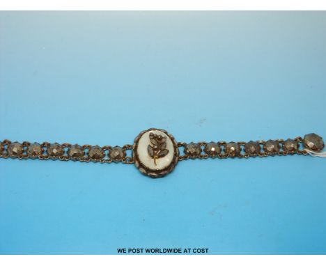 A Georgian cut steel bracelet formed of an oval mother of pearl plaque to the centre with large circular faceted stones makin