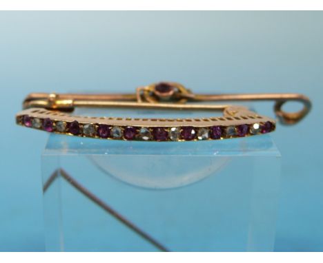 A gold brooch set with alternating diamonds and rubies, yellow metal brooch marked 9ct set with an amethyst and an Edwardian 