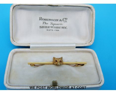A yellow metal brooch in the form of a fox's head set with ruby eyes, in original box for Robinson & Co Shrewsbury
