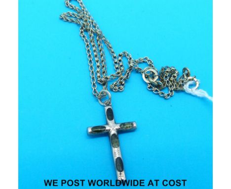 A 9ct gold crucifix inset with jade/oynx cabochons on a yellow metal chain