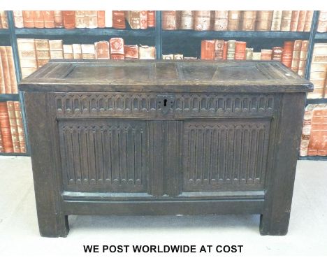 An antique oak peg jointed coffer with carved front panel (W97cm x D45cm x H58cm) 