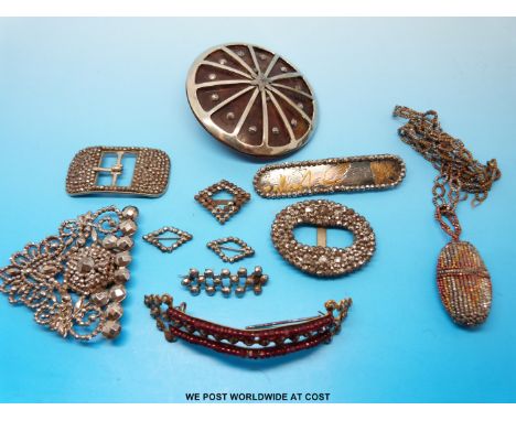 A collection of  cut steel items to include four 19thC buckles one marked L.W Paris, a button set with faux tortoiseshell, th