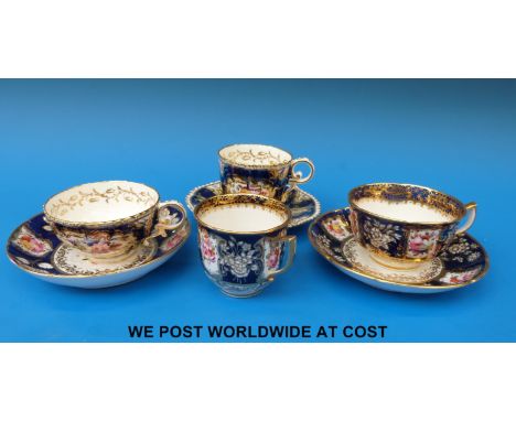 Three 19thC Coalport hand painted cups and saucers, decorated with flowers against a blue ground and an odd cup