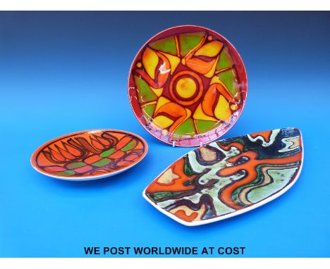 Three Poole pottery plates/dishes including a spear shaped example, various signatures verso
