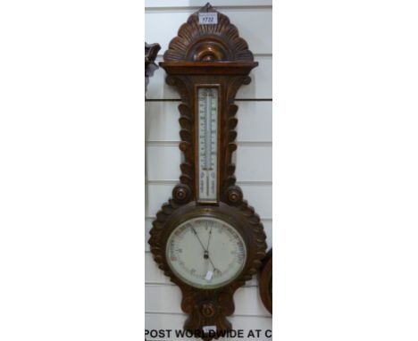 A carved oak aneroid barometer 