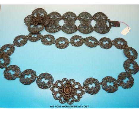 An early 19thC Berlin ironwork bracelet by Geiss composed of four stylized foliate links and a floral clasp together with a m