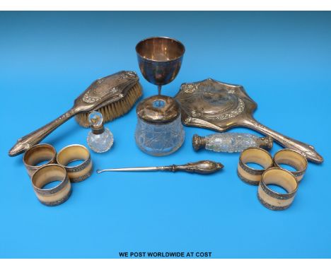 A hallmarked silver mounted hand mirror and matching brush, together with a silver handled button hook, three hallmarked silv