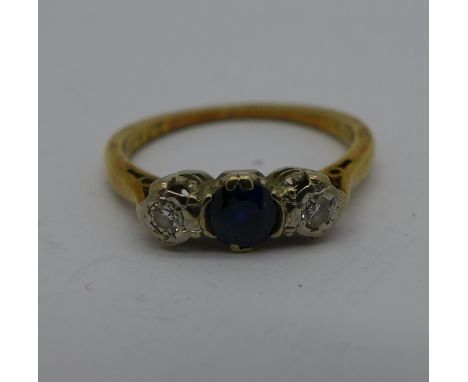 An 18ct gold and three stone diamond and sapphire ring, 2.3g, K