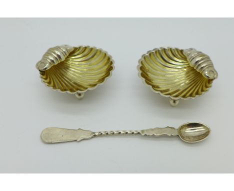 A pair of white metal salts and a white metal spoon