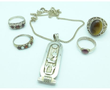 An Egyptian silver pendant and four silver rings including one with Victorian hallmark set with opals and garnets, K