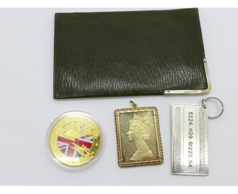 A silver key fob, a silver gilt key fob, a gilt metal and enamel coin and a silver mounted wallet, 60g