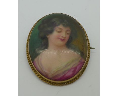 A signed 9ct gold framed porcelain plaque portrait brooch, the back marked 'hand painted, Leslie Johnson', 54mm x 43mm