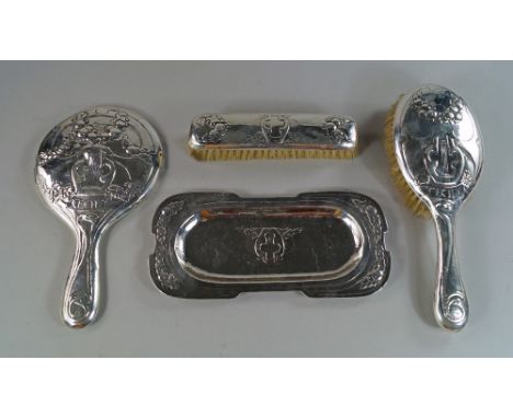 A unique silver Art Nouveau dressing table set, London c.1908, markers mark S.L.R (unidentified) comprising hand mirror and h