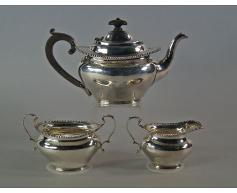 A George V silver three piece tea set, Birmingham 1910, Thomas Edward Atkins, comprising teapot, milk jug and sugar basin, wi