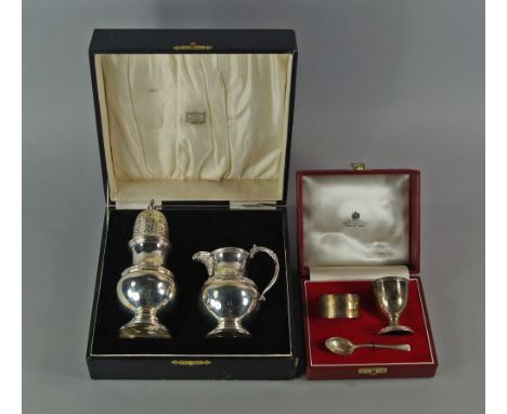 A silver sugar caster and matching cream jug, cased, Birmingham 1933, Adie Brothers Ltd, together with a cased child's Christ