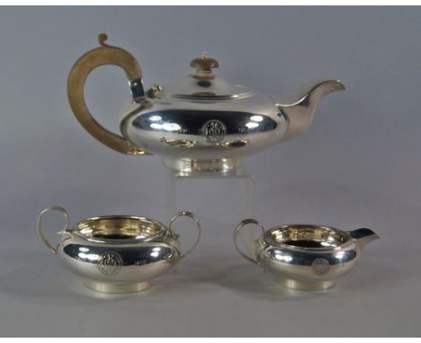 A George V silver three piece tea set, Sheffield 1926, Thomas Bradbury & Sons Ltd, of plain squat form, comprising teapot, mi