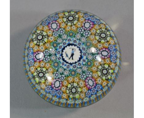 A Baccarat paper weight, Golfer with millefleur surround, marked to base 273 and with cane in the glass, 8.5cm diameter