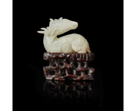 GROUP OF TWO MING STYLE PALE CELADON JADE CARVINGS 明式青白玉雕鹿及人物擺件（一組兩件）comprising: a recumbent deer turning its head towards th