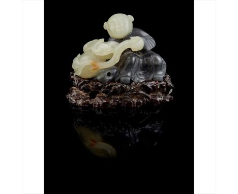 CELADON JADE CARVING OF A BOY QING DYNASTY, 19TH CENTURY&nbsp;清 青玉巧雕多子多福擺件 cleverly carved with a boy sitting and leaning to 
