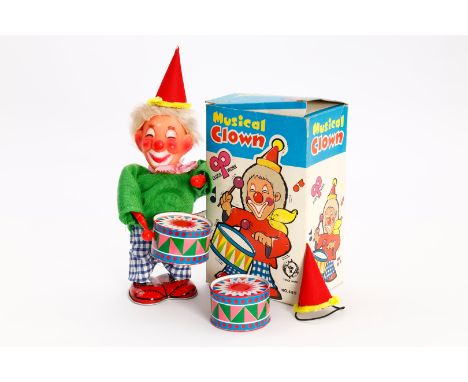 R Japan Automat ”Musical Clown”, Uhrwerk intakt, mit 2 Trommeln und 2 Hüten, 1 Loch im Hemd vorne, H 16, OK, sonst Z 2