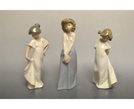 A Nao figure of a girl holding her purse, boxed; others, similar, boxed (3)