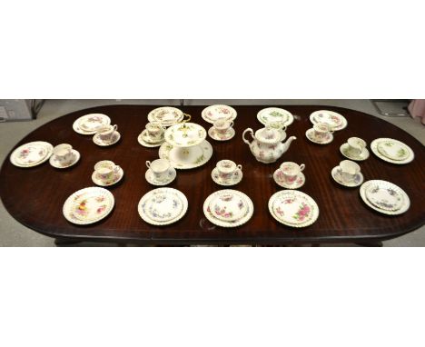 A Royal Albert Flowers of the month tea service for twelve, comprising two tier cake stand, teapot, side plates, dessert plat