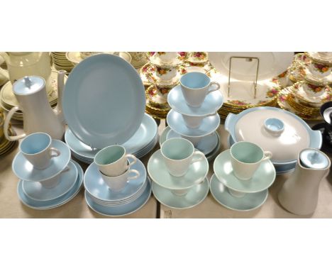 A Poole twelve setting tea set, comprising tea pot, cups and saucers, etc; conforming casserole dishes.