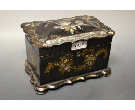 A Victorian papier mache shaped rectangular tea caddy, hinged slightly domed top with wavy-edge, fitted with two lined divisi