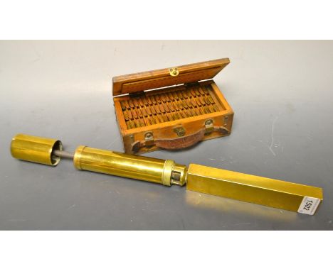 A manual brass fluid testing pump and box of graded filters.