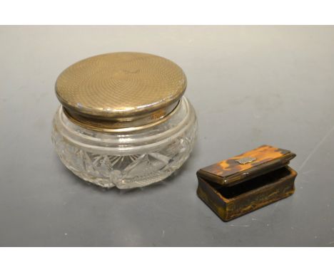 An early 19th century horn snuff, hinged cover, shield shaped cartouche, 5.5cm wide; a silver topped dressing table jar, engi