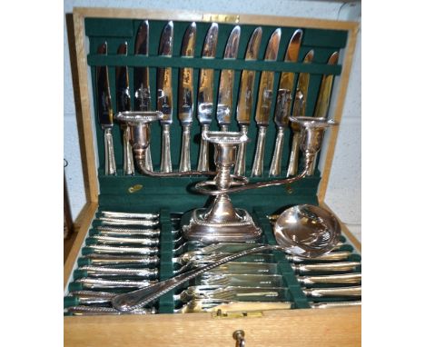 A Dixon silver plated oak canteen of cutlery for eight; a Dixon silver plated ladle; a silver candelabra