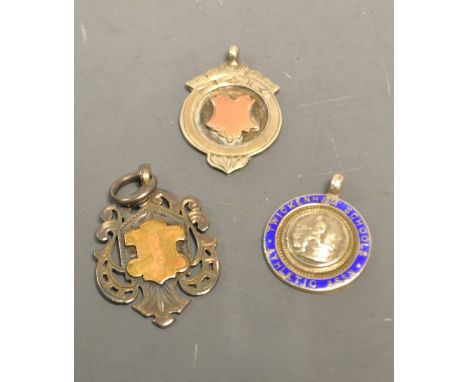 A silver and enamel medallion; two silver medallions, gold shields