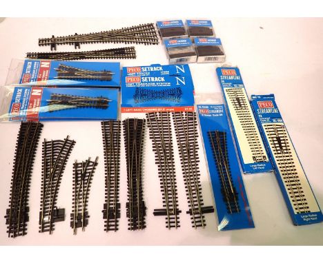 Nineteen assorted Peco points including three way, crossover, curved etc. and four PL9 mounting plates. P&amp;P Group 1 (£14+