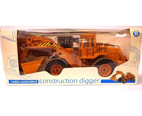 Radio controlled digger, forward reverse, left and right, digger fork up and down. As new and boxed. Approximate L: 50 cm. P&