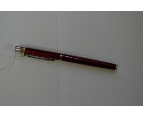 A Cartier red lacquer roller ball pen. 