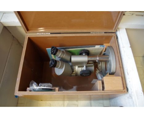 An Olympus binocular microscope,&nbsp;cased and with instructions.&nbsp; 