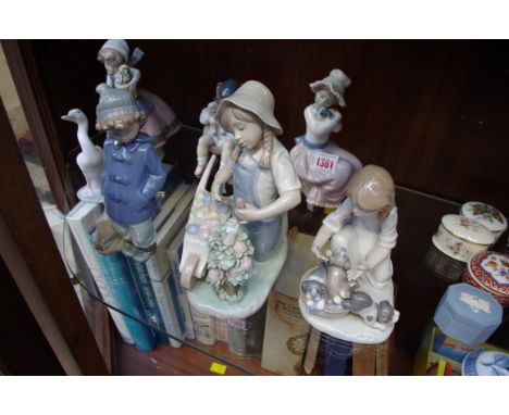 Four Lladro figures; together with three similar Nao figures.&nbsp; 