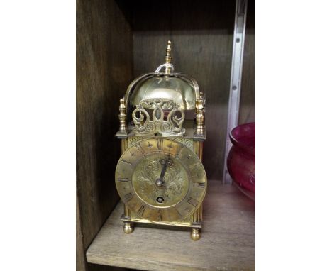 A small brass lantern style clock,&nbsp;23.5cm high.&nbsp; 