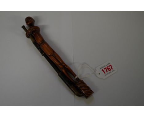 An Oriental cloisonne enamel pipe,&nbsp;with unusual carved wood figural stand, 21cm long.&nbsp; 
