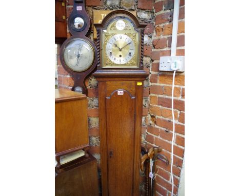 A 1920s oak musical mantel clock, on longcase stand, total height 173cm.&nbsp;&nbsp; 