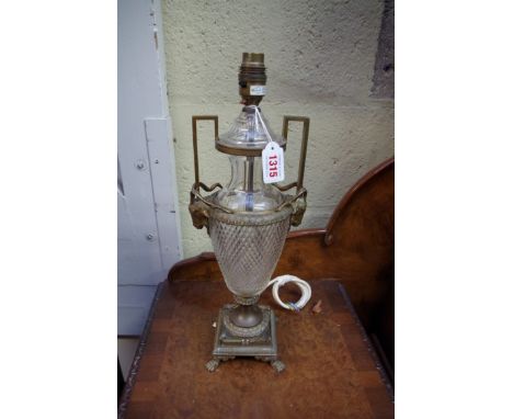 A brass and cut glass twin handled table lamp, in the Adam style, one foot stamped 'Made in Vienna'. 