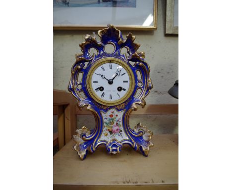 A late 19th century Continental porcelain mantel clock,&nbsp; the enamel dial inscribed 'Potonie, Paris', 27.5cm high. 