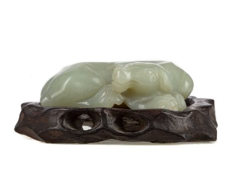 CHINESE CELADON JADE CARVING OF A BUFFALO CALF,modelled recumbant, 6cm wide, with associated stand